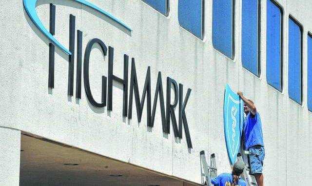 Ted Morris and Mike Nally of MAC Sign Co. in Scranton work to put up a new Highmark Blue Cross and Blue Shield sign on one of the company's buildings on North Main St in Wilkes-Barre in 2015 following Blue Cross of NEPA's merger into the Highmark system. - Times Leader file photo